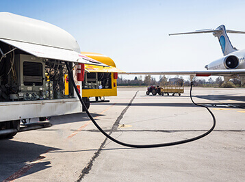 An airport fuelling vehicle dispensing fuel to an aeroplane