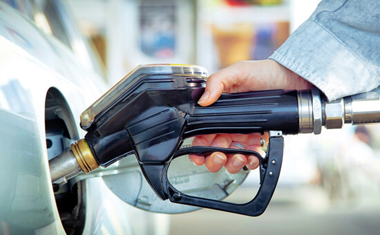 Person putting fuel into a car