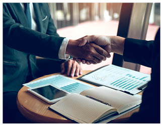 Two businessmen are talking and making deals on business operations and agreeing by shaking hands in the office 