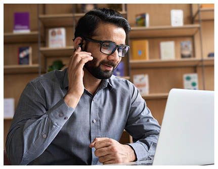 Indian business man professional employee, remote consultant, customer service support manager wearing headset talking at virtual meeting consulting client on video call at home office call center 